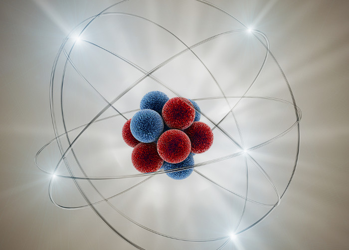 Representação de um átomo e suas partículas: nêutrons e prótons no núcleo, e elétrons girando ao seu redor